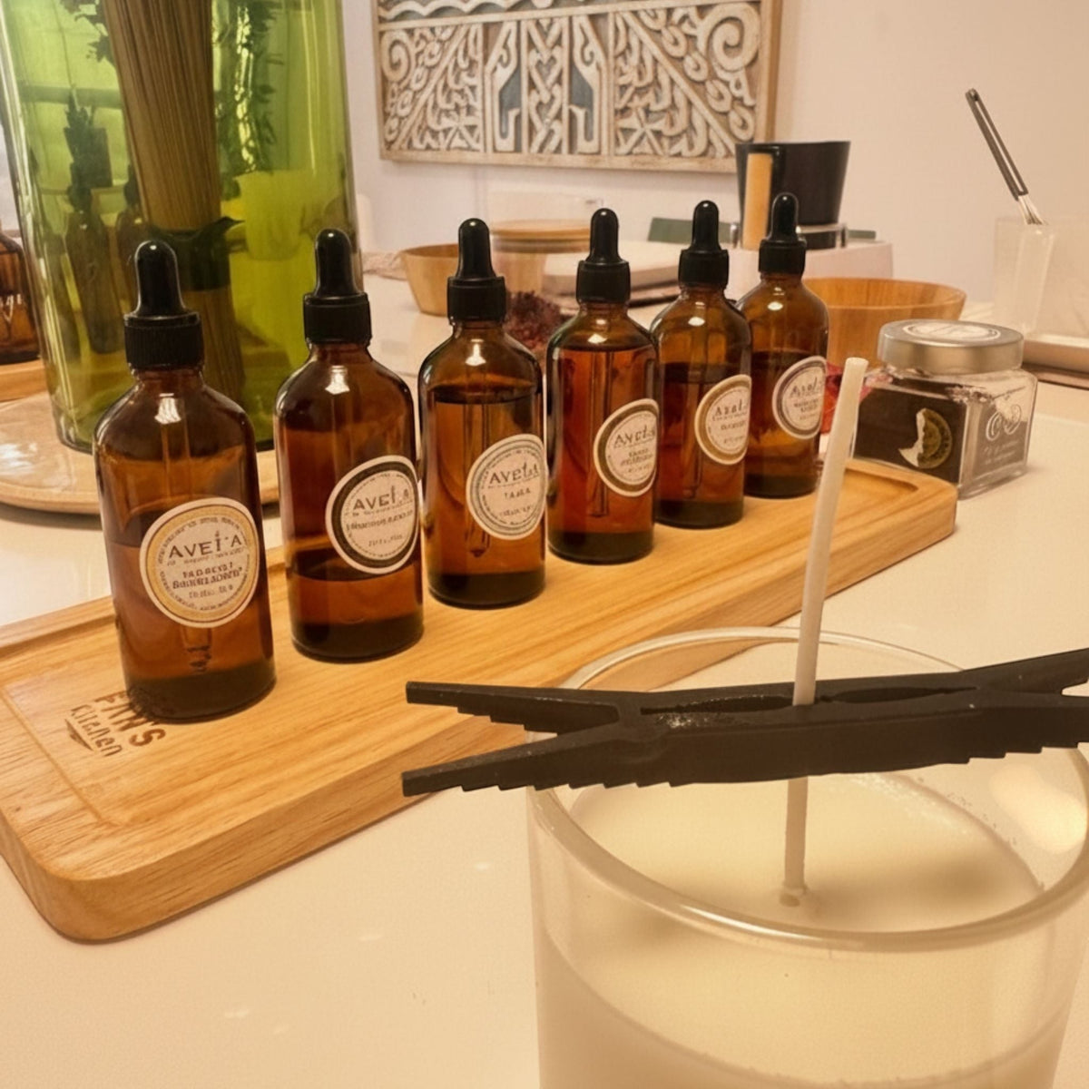 Atelier créatif Tahiti Candles avec flacons de parfums ambrés et bougie artisanale en cire de soja en préparation
