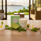 Bougie parfumée Tahiti Candles Lime Basil 80g en pot de verre avec citron vert et fleurs de tiaré sur une table